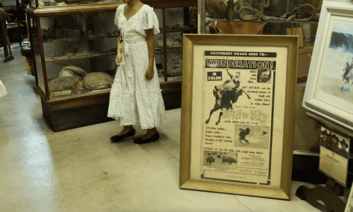 Girl dressed in a white costume rental dress walking through the Casey Tibbs Museum